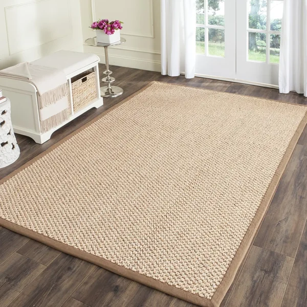 Beige braided jute rug on wooden floor